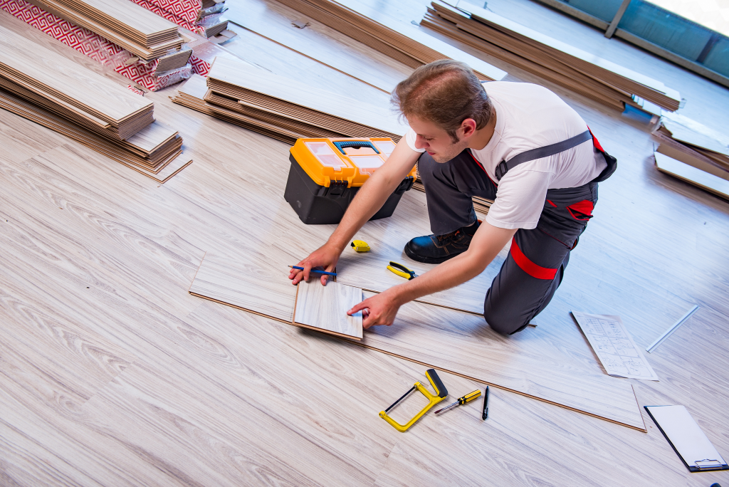 Our Worker installing flooring in Fort Collins, CO, showcasing our best flooring services